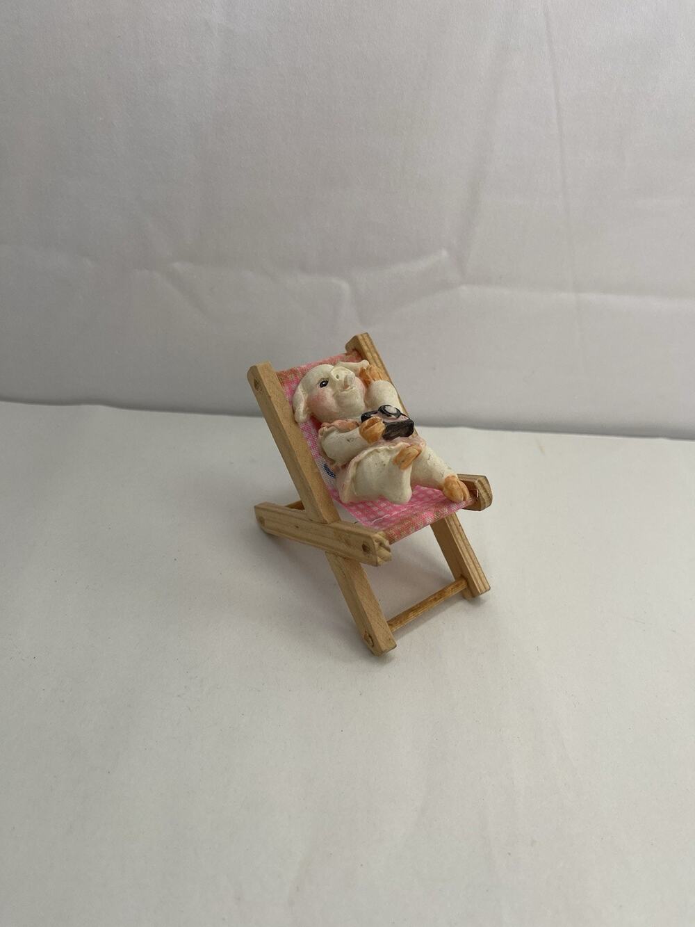 Miniature Pig Figurine Relaxing in Pink Beach Chair